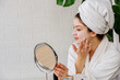© lordn - Young woman applying face mask at home. Natural Skin Care Routine. Cleaning face with natural cosmetics.
