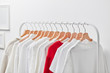 © 365mm/Stocksy - Distinctive red shirt on hangers among white clothes