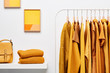 © 365mm/Stocksy - Bright yellow clothing in wardrobe room