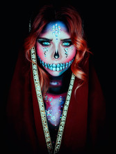 Woman In Mantle Cape With Makeup In Calavera Style. Minimal Retouching Processing. Turquoise Watercolor Eyes. Celebrating The Day Of The Dead. Close-up Portrait. Pattern With Rhinestones On The Face.