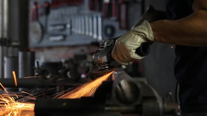 Wall Mural - Man work with angle grinder, goggles and construction gloves, grinder metal in garage workshop, do it youself concept, sparks close up