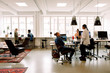 © Maskot - Male and female business colleagues working in creative workplace