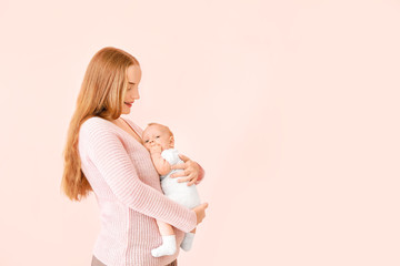 Poster - Mother with cute baby on color background