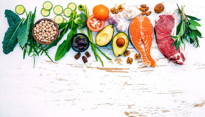 Ketogenic low carbs diet concept. Ingredients for healthy foods selection on white wooden background. Balanced healthy ingredients of unsaturated fats for the heart and blood vessels.