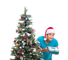 Young man decorating christmas tree isolated on white