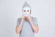 © Ranta Images - Young man with tinfoil hat as conspiracy theory concept wearing white mask