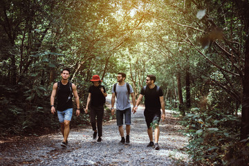 Group of traveler friends walking together at rain forest,Enjoying backpacking concept