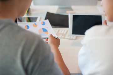 Two new businessmen discuss the market share and the marketing strategy of the business. Consultation to plan investment and adjust the proportion of the portfolio according to market conditions.