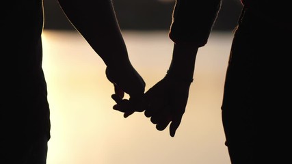 silhouette lovers hold hands together love each other forever during the sunset golden light, romant