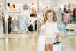 © Elena - shopping. discounts. little girl shopaholic. girl with shopping bags in hands. white bags copyspace. shopping center, shopping. emotions