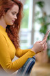 © ZoomTeam - Woman taking a selfie with a smoothie using a mobile phone for her social media blog. Sexy  blogger shooting photos for her blog at home.