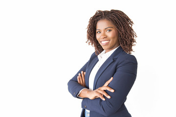 Happy successful female professional smiling at camera. Young African American business woman with arms crossed standing isolated over white background. Confident businesswoman concept