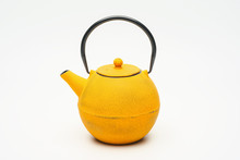 Yellow Cast Iron Teapot On A White Background.