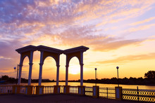 Arch On The Embankment On The Banks Of The Dnieper River At Sunset Background. Kherson Region.