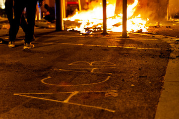 Barcelona, Spain - 16 october 2019: acab word on asphalt street wih fire in the background during clashes and riots with police