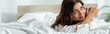 © LIGHTFIELD STUDIOS - panoramic shot attractive woman lying in bed at morning