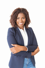 Wall Mural - Happy successful female agent looking at camera. Young African American business woman with arms crossed standing isolated over white background, smiling. Business portrait concept