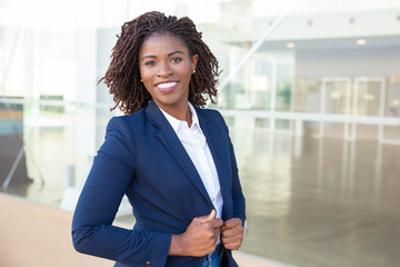 happy confident professional posing near office building. young african american business woman stan