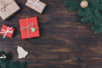 Wall Mural - Top high angle close up view photo of festive natural rustic composition of different packed giftboxes evergreen branches with place for design text