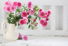 Pink Chrysanthemums In Jug On Old  White Wooden Bench