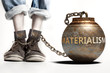 Materialism can be a big weight and a burden with negative influence - Materialism role and impact symbolized by a heavy prisoner's weight attached to a person, 3d illustration