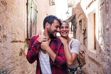 Wall Mural - Tourist love couple walking in a town