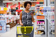 © Nejron Photo - Pretty black woman choosing goods in a grocery store