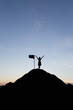© cofficevit - Silhouette of people and flag on top mountain, sky and sun light background. Business success and goal concept.