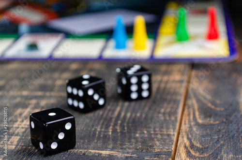 three black dice for a board game on the board Tableau sur Toile