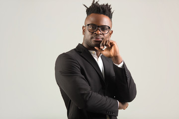 Wall Mural - handsome young african man in black suit wearing glasses