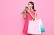 © Shopping King Louie - Attractive young girl in a dress with a bouquet of flowers, and shopping on a pink background.