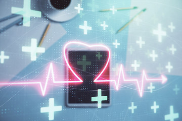 Double exposure of heart hologram on digital tablet, table background. Concept of medical education