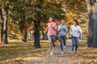 © BalanceFormCreative - Group of female friends jogging at the city park.Autumn season.