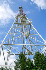 TV tower on a background of blue sky with clouds