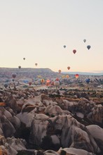 Hot Air Balloons Flying Over Mountains, Cappadocia, Turkey