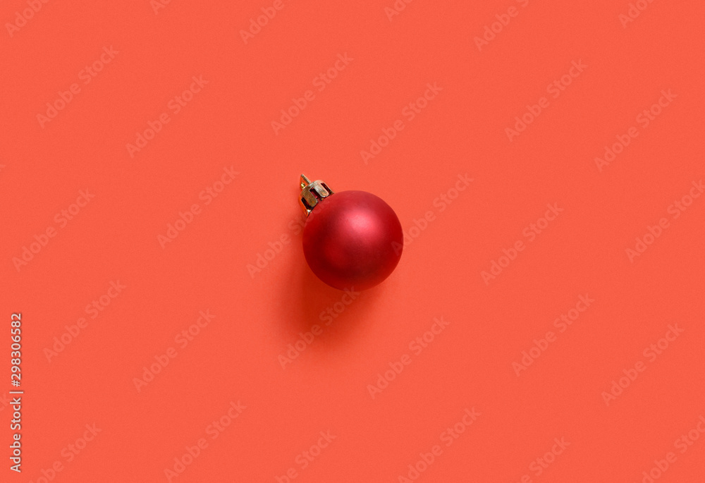 Red Christmas bauble on a red background - obrazy, fototapety, plakaty 