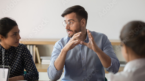 Cuadros en Lienzo Confident male boss explaining ideas to diverse team at office