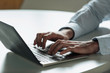 © PhotoAlto - Young businessman's hands typing on laptop