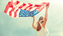 Country, Patriotism, Independence Day And People Concept - Happy Smiling Young Woman In White Dress With National American Flag Outdoors