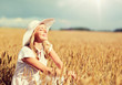 © Syda Productions - nature, summer holidays, vacation and people concept - happy young woman in white dress and sun hat enjoying sun on cereal field