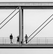 Beautiful black and white view of some people photographing themselves on a suspension bridge in central Berlin, Germany