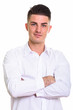 © Ranta Images - Close up of young handsome man with arms crossed
