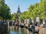 Fototapeta  - Canal and church tower in Gouda, Holland