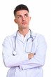 © Ranta Images - Studio shot of young handsome man doctor thinking with arms cros