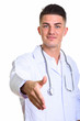 © Ranta Images - Close up of young handsome man doctor giving handshake