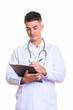 © Ranta Images - Young handsome man doctor writing on clipboard