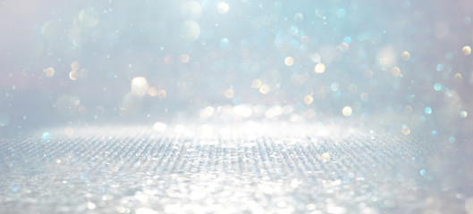 abstract backgrounf of glitter vintage lights . silver and white. de-focused. banner