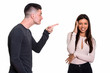 © Ranta Images - Studio shot of young couple with man pointing finger and woman l