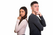 © Ranta Images - Studio shot of young couple thinking together back to back