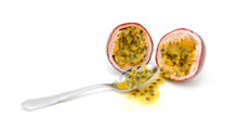 Spoon Scooping Out Pulp And Seeds From A Passion Fruit
